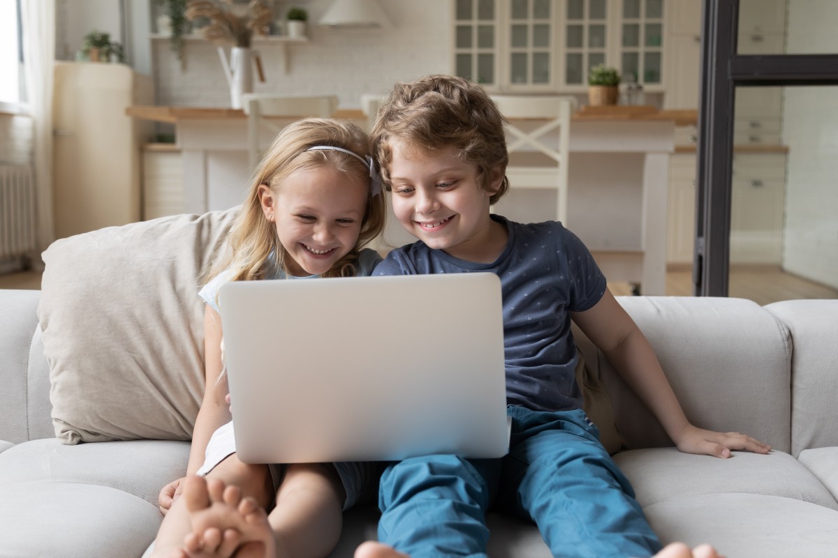 Boy and girl sharing a computer.