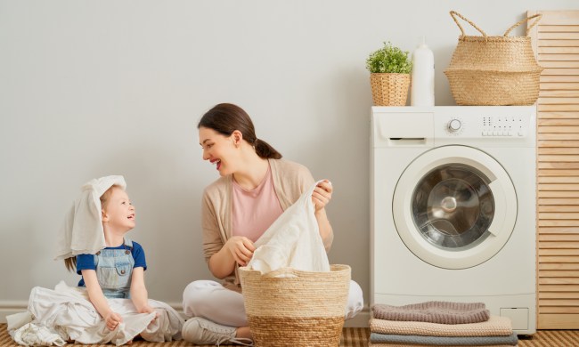 Mom with young daughter doing laundry