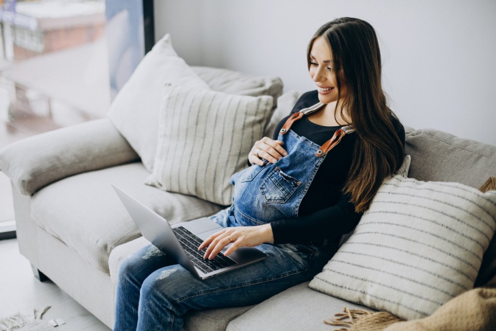 Pregnant woman on computer.