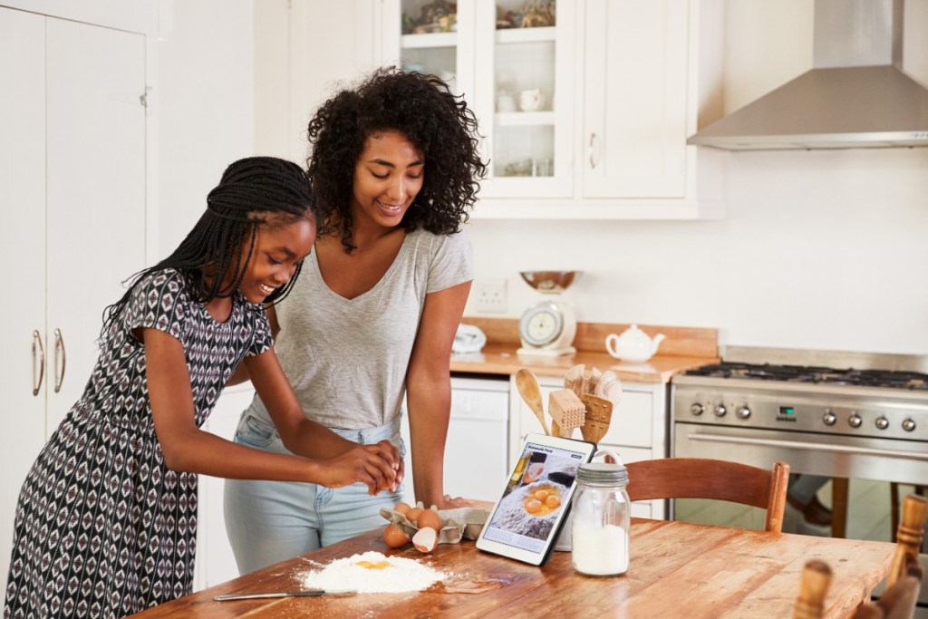 teen and mom baking together
