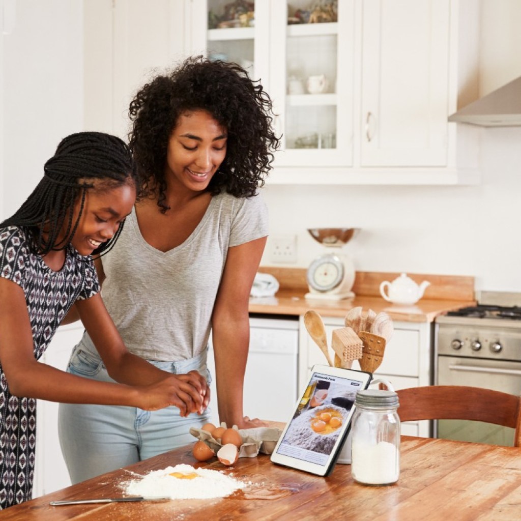 teen and mom baking together
