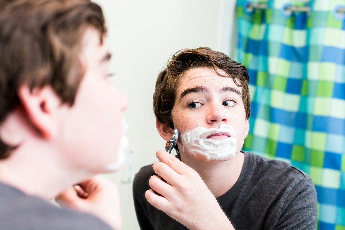 Teen boy shaving
