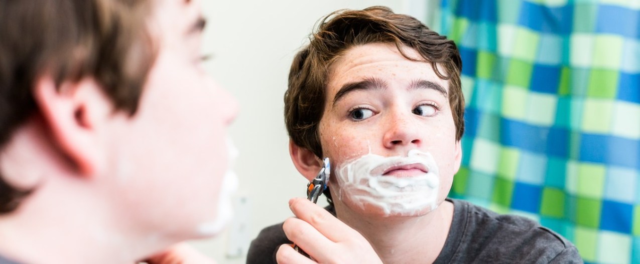 Tween boy shaving