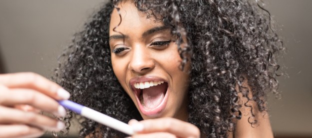 Woman excited at pregnancy test