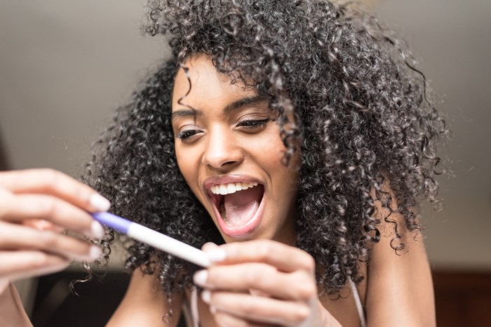 Woman excited at pregnancy test