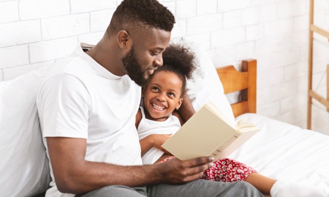 Dad reading to his daughter