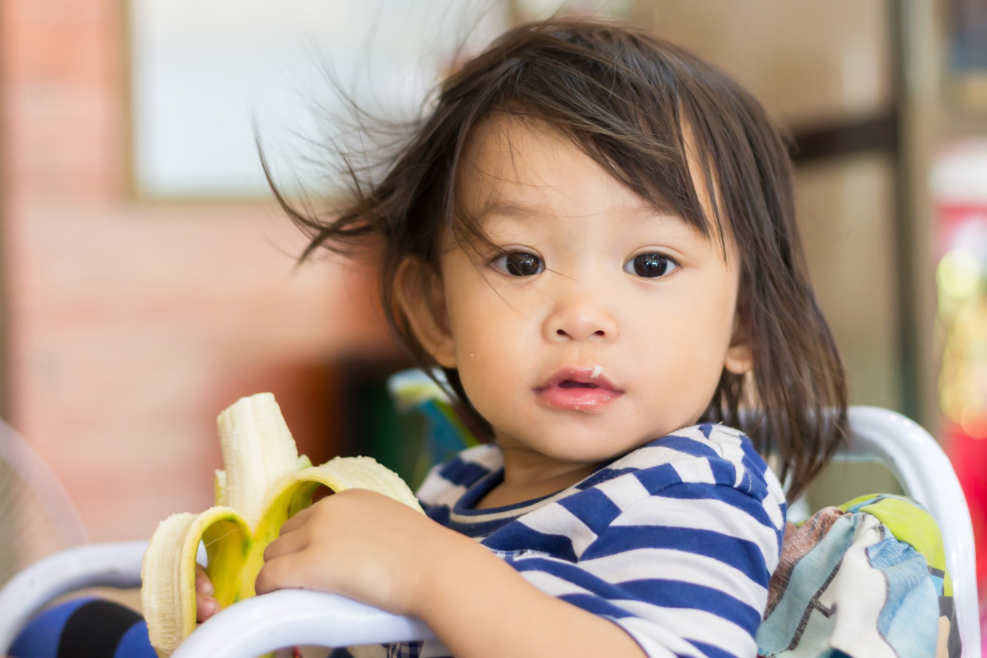 Toddler eating a banana