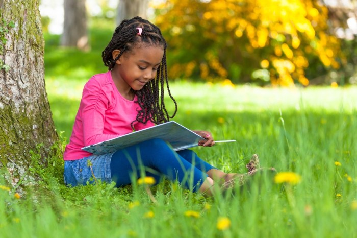 Girl reading under tree