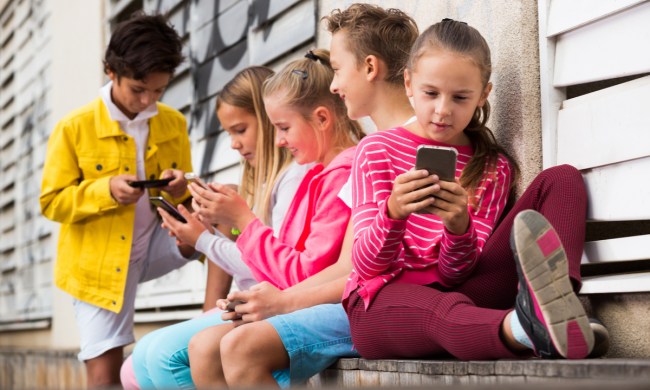 A group of kids on their phones.