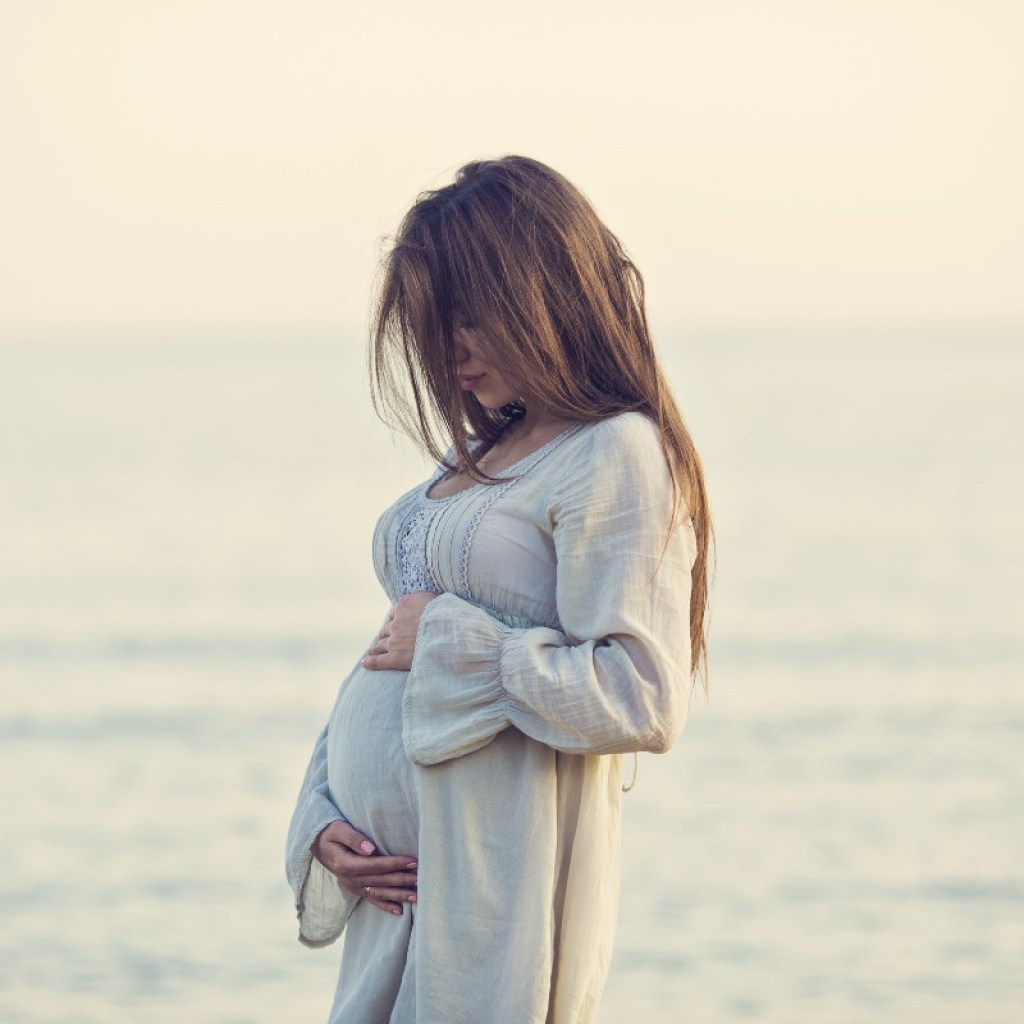 Pregnant woman on a beach