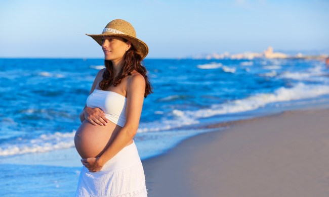 Pregnant woman walking on a beach