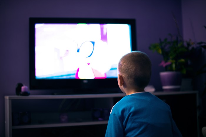Child sitting in front of the TV