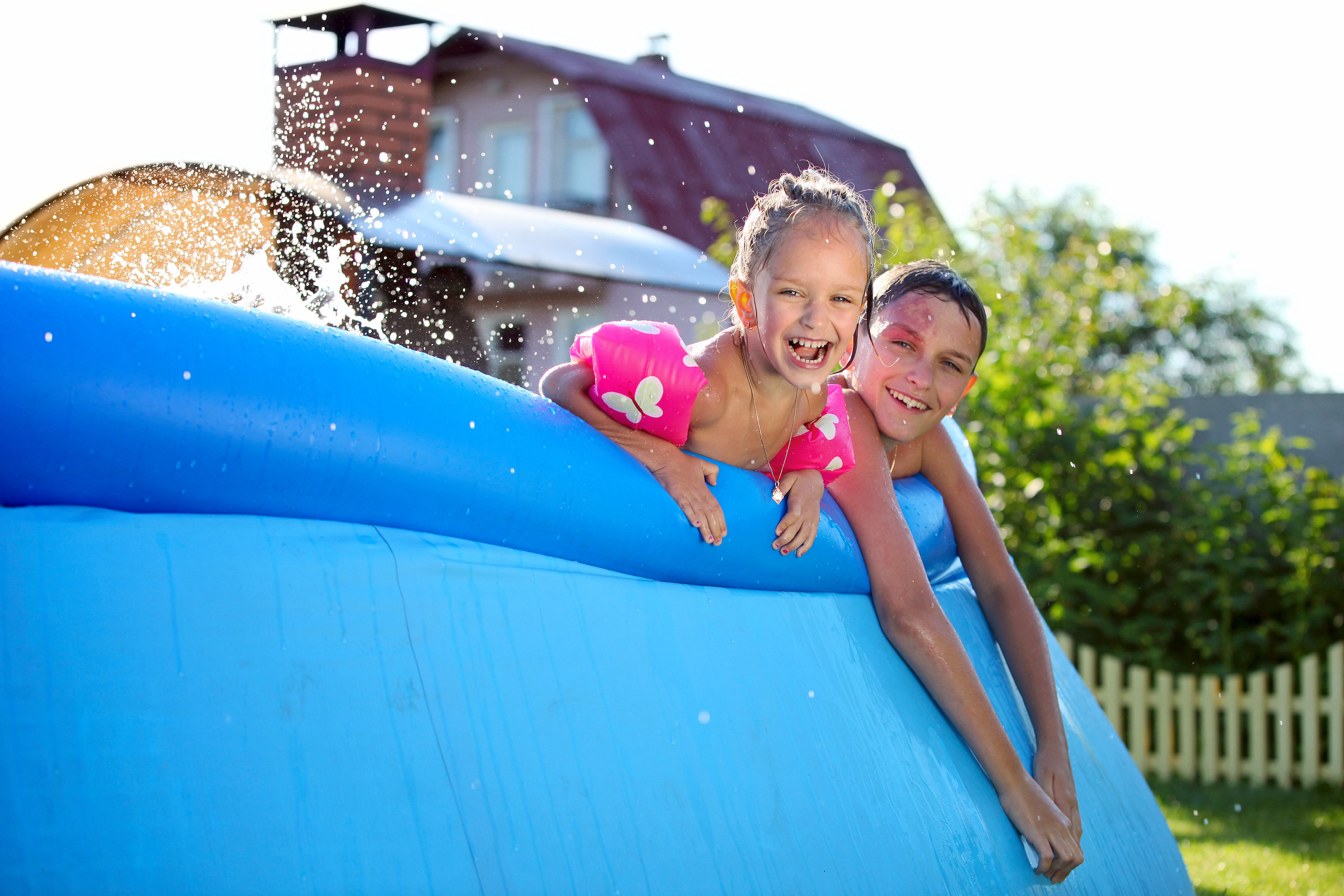 Two siblings in a pool