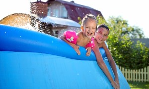 Two siblings in a pool.