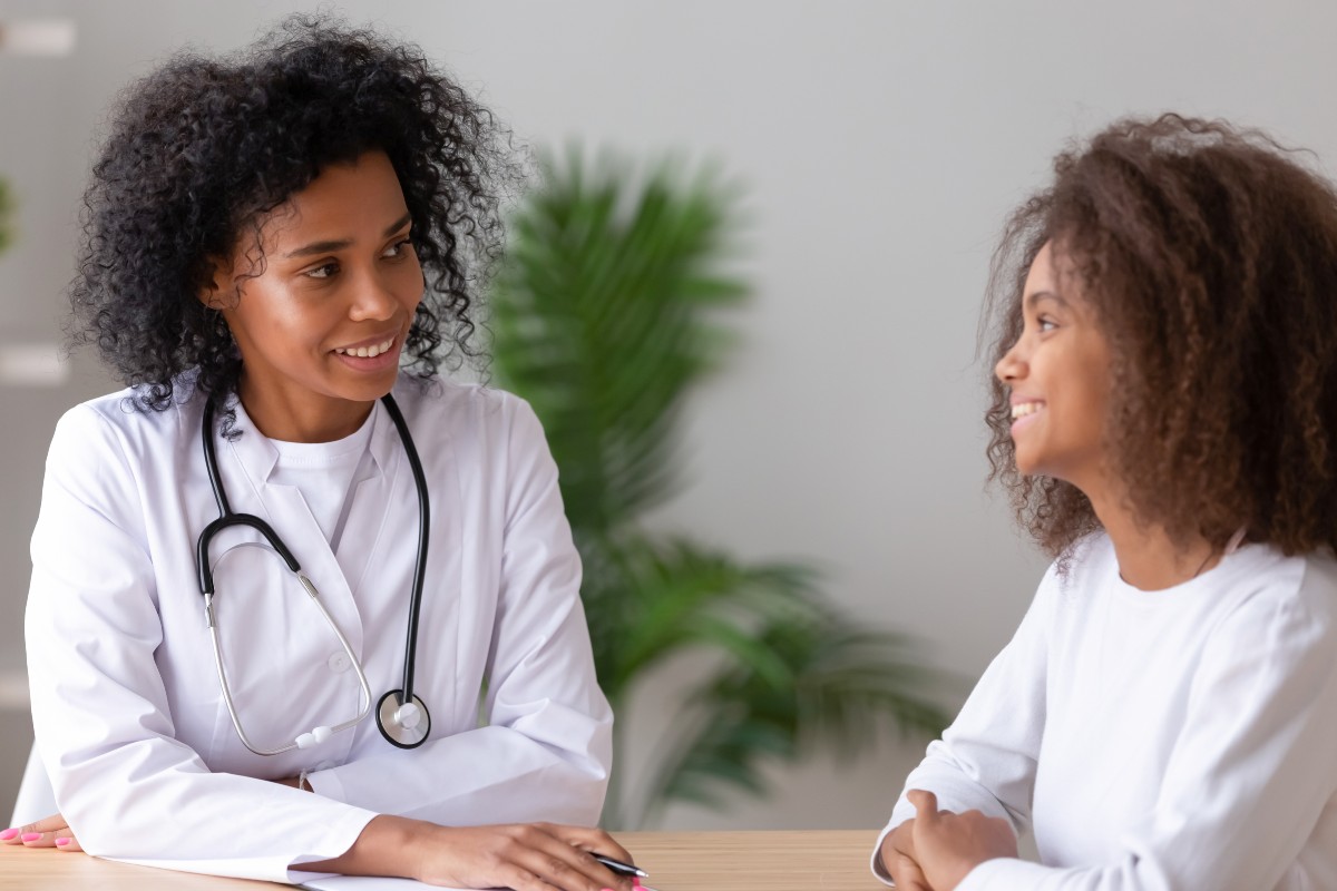 Teen girl talking with a doctor.
