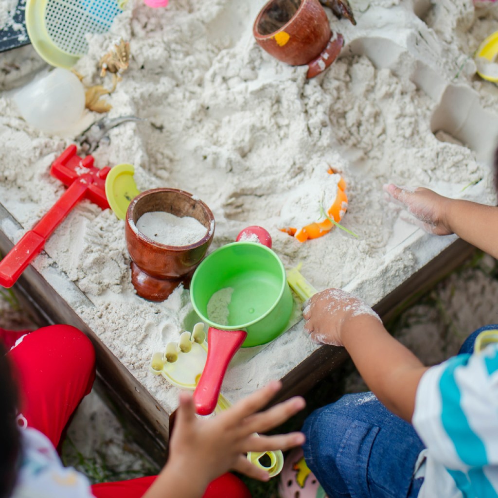 Toddlers playing with sand