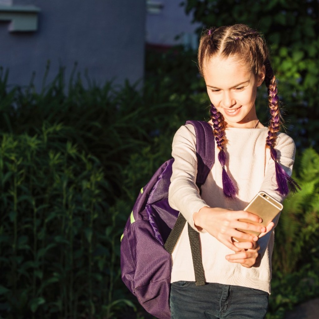 tween taking selfie