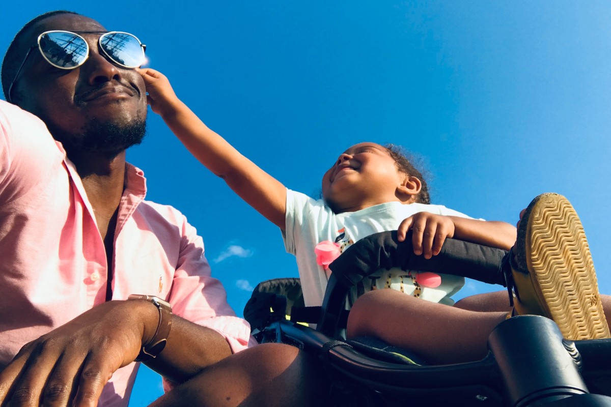 dad and child in stroller on a sunny day