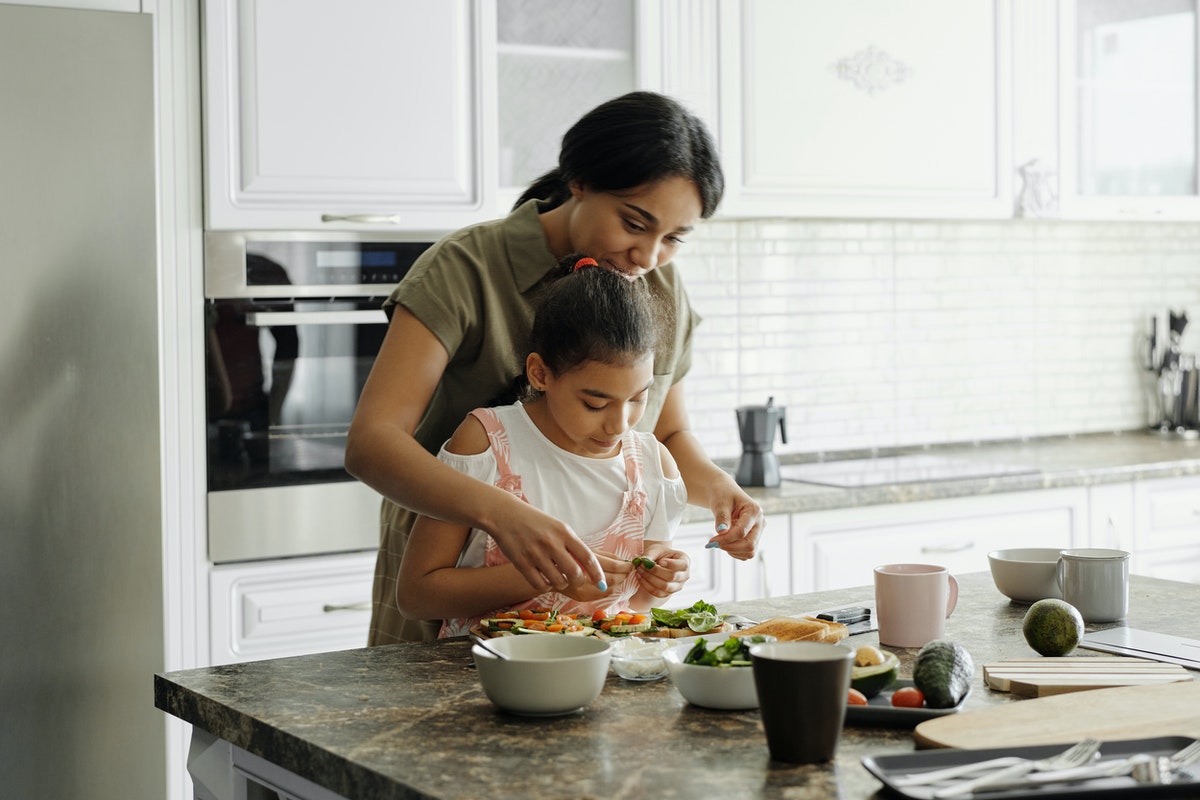 Mom and daughter making avocado toast