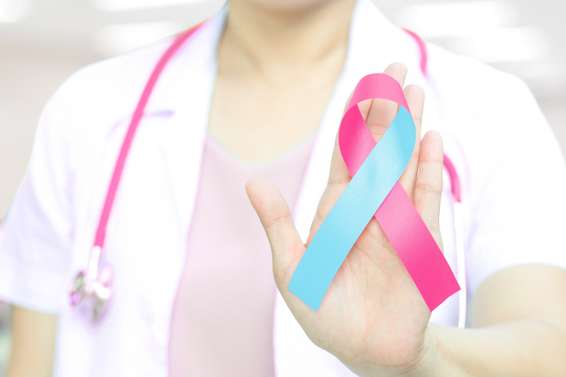 Doctor holding an infant loss awareness ribbon