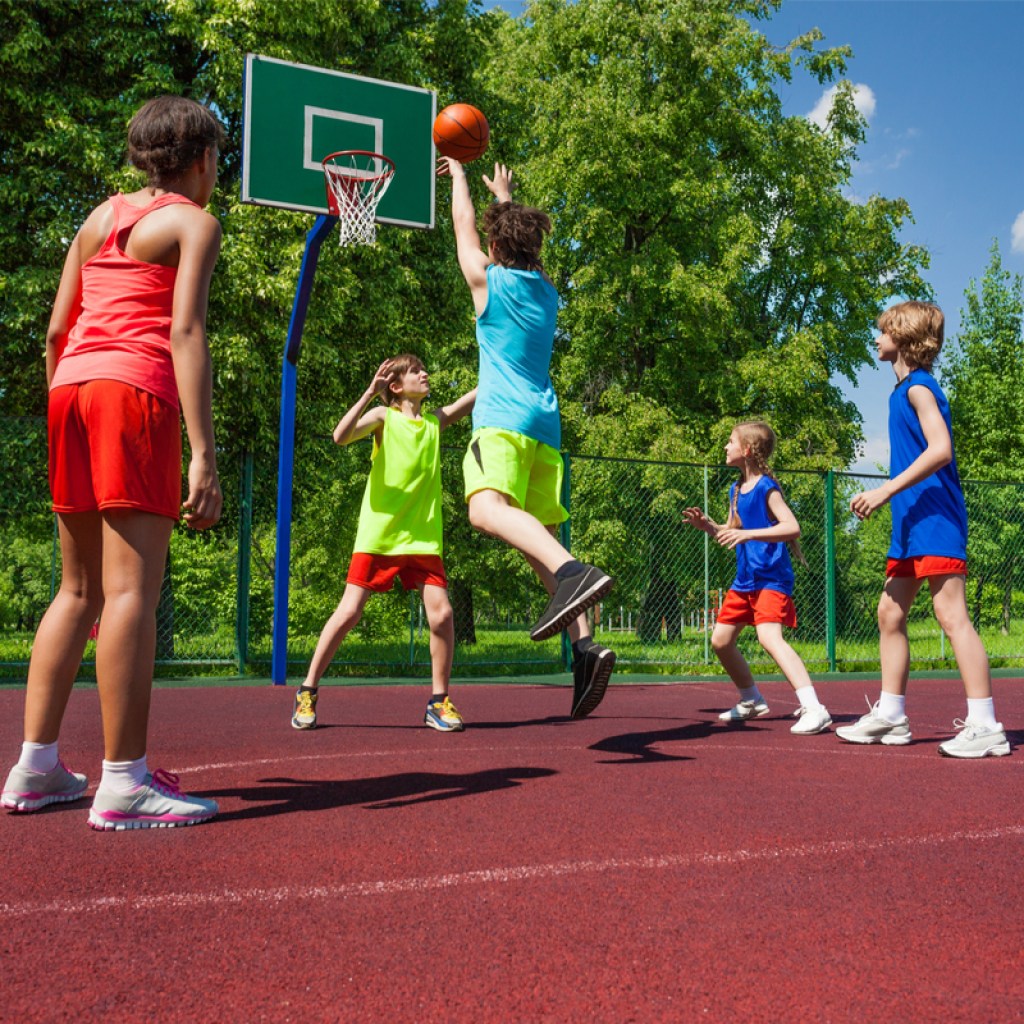 Kids having fun playing basketball outside
