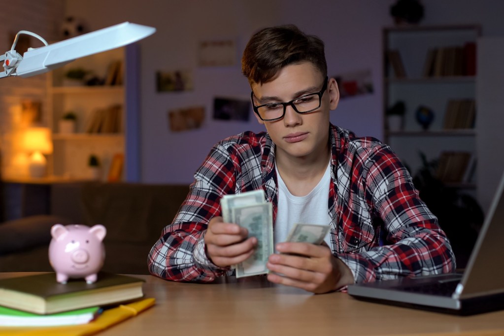 Teen boy counting money