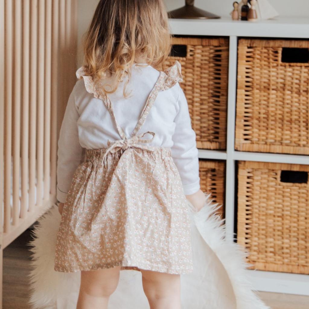 little girl standing in front of shelves