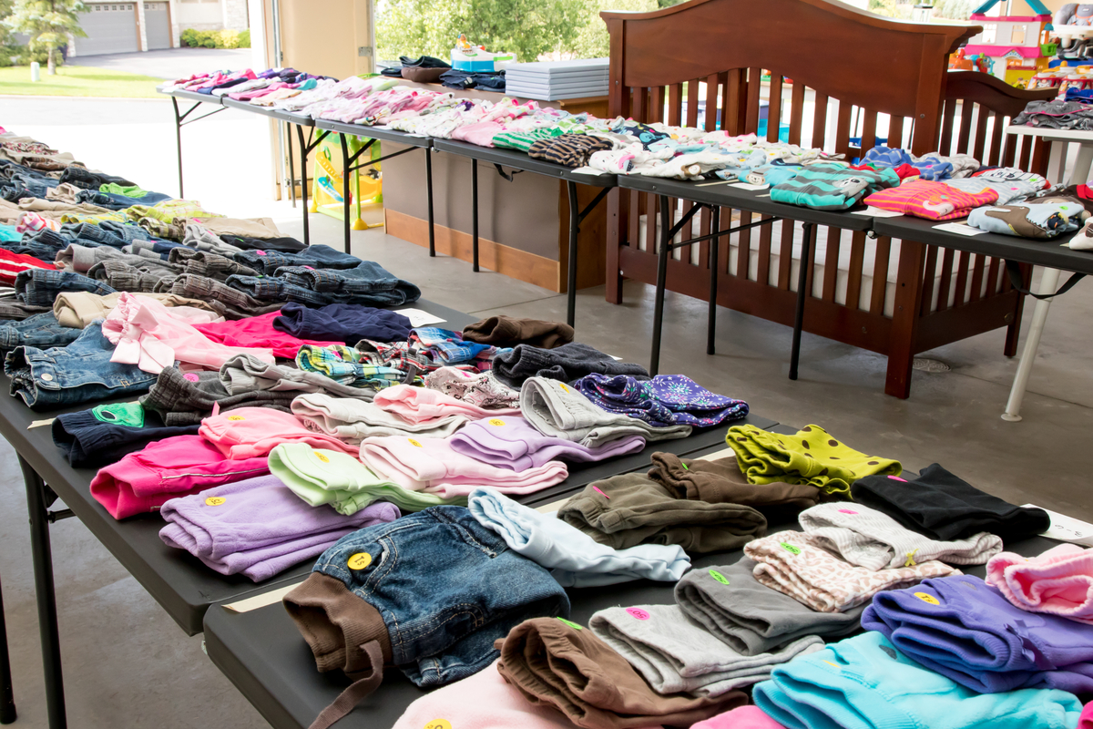 clothing for sale neatly set up on tables at garage sale