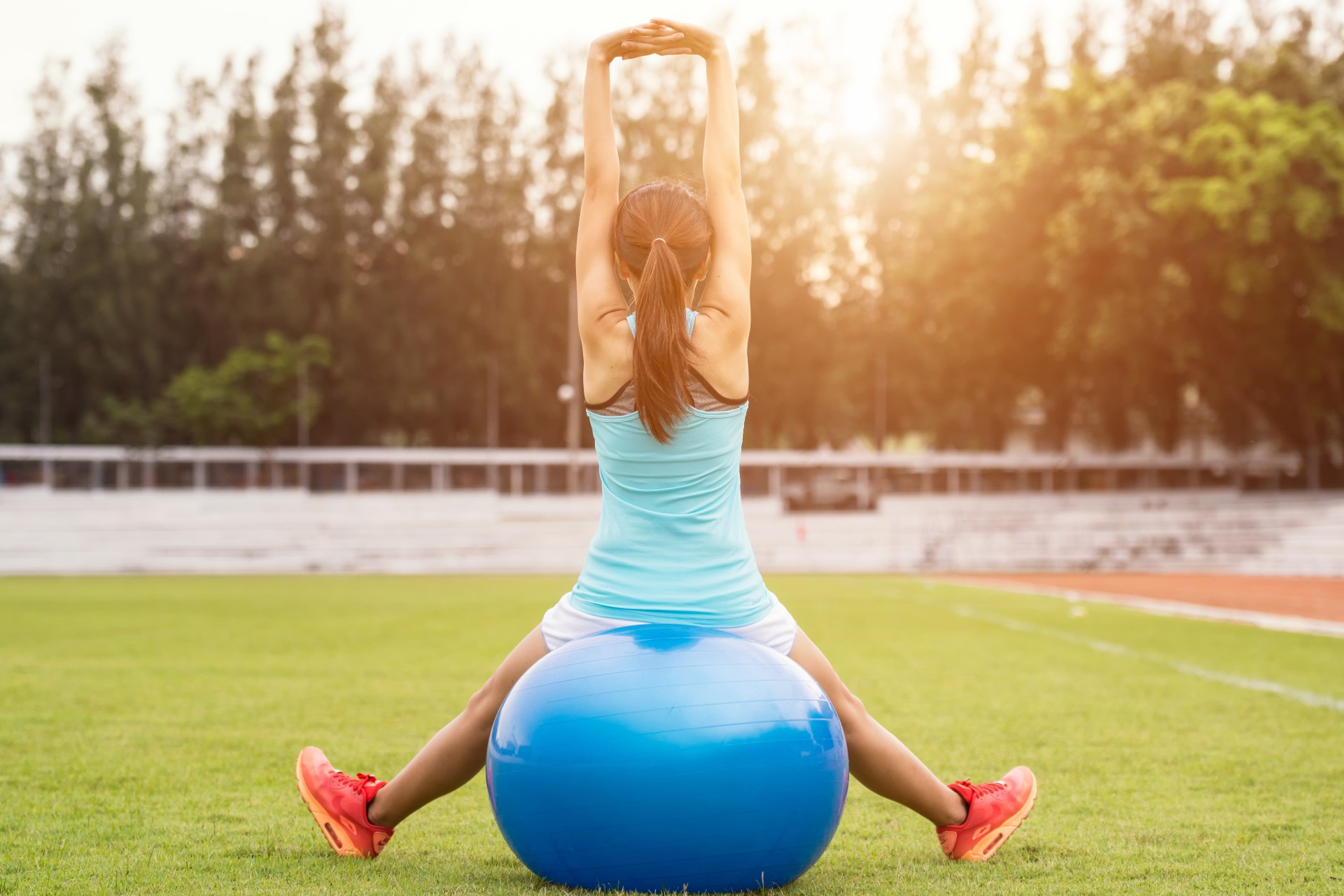 Post-partum woman stretching on a yoga ball.