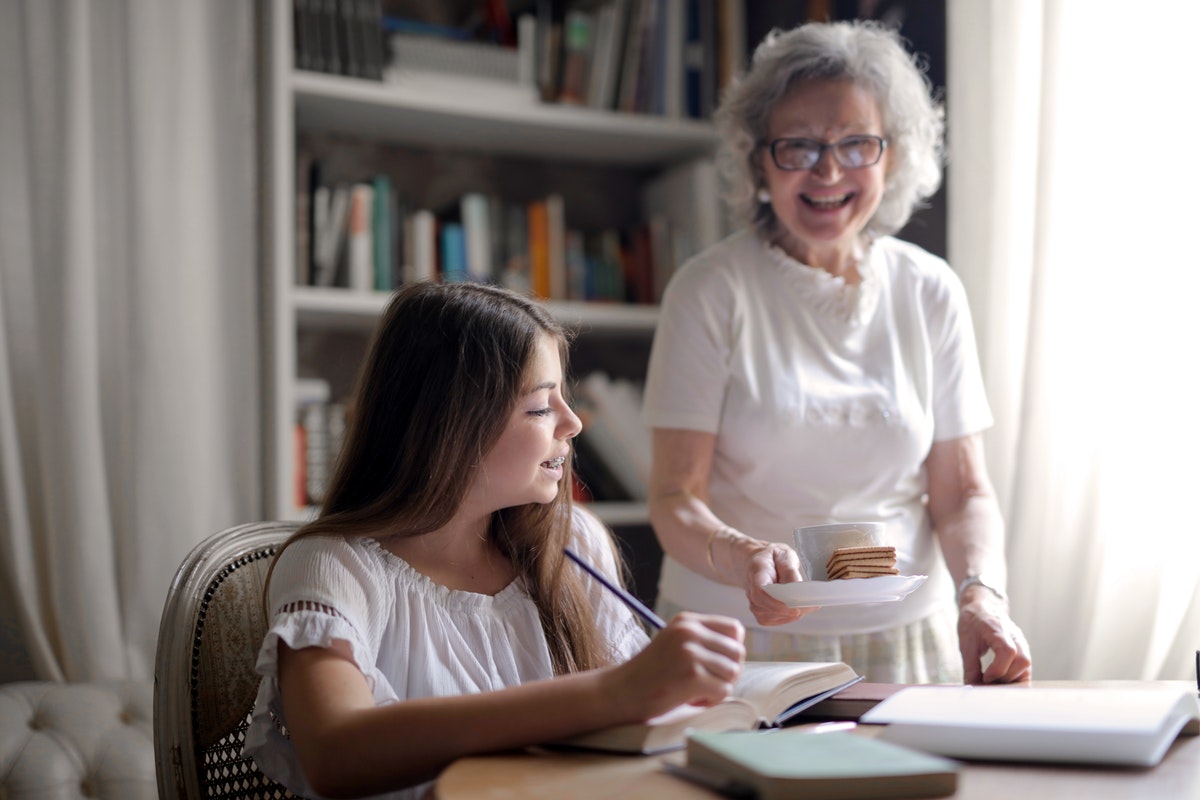 grandmother bringing snack to teen