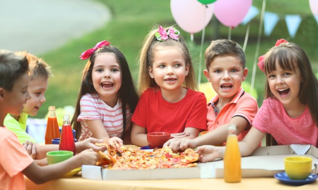 Kids enjoying eating pizza at a birthday party