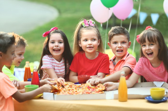 Kids enjoying eating pizza at a birthday party