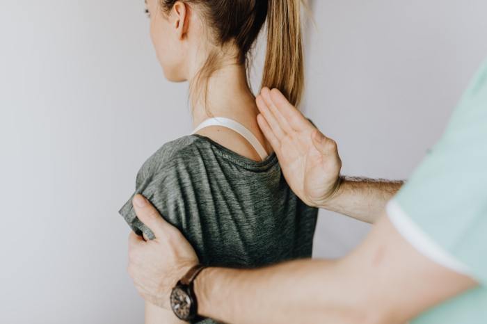 chiropractor assessing spine condition