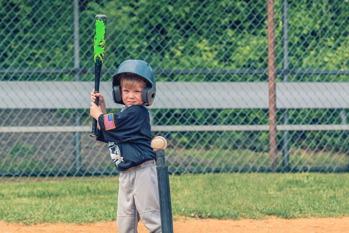 preschooler playing t- ball