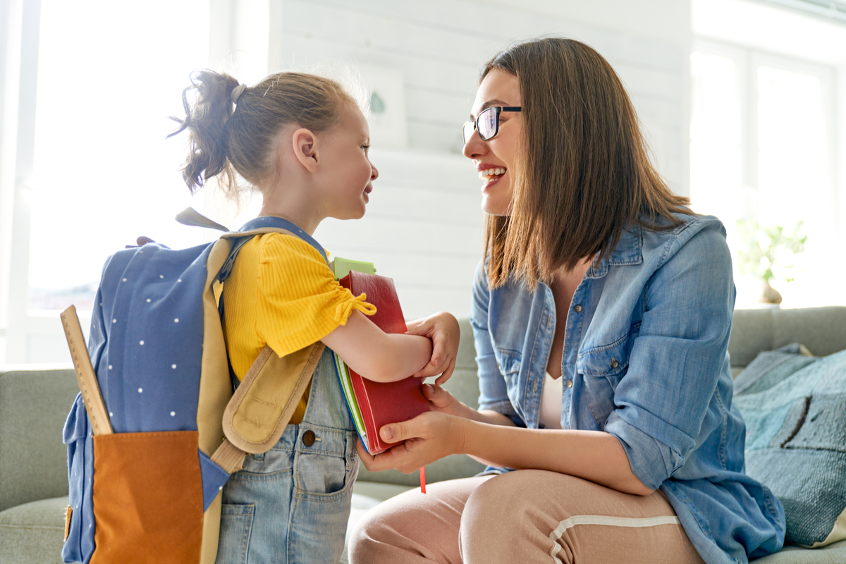 A mom and child getting ready to go to school.
