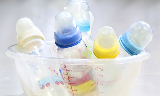 A cluster of different baby bottles in a bowl.