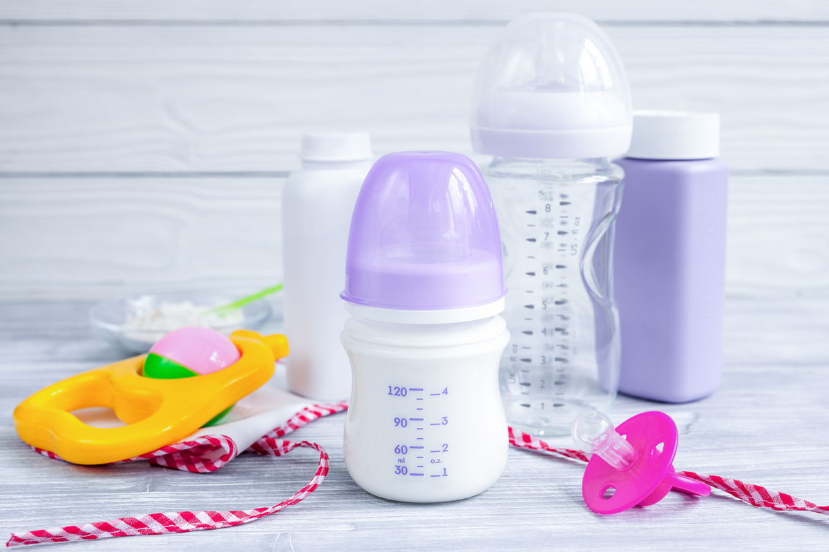 A few baby bottles on a table.