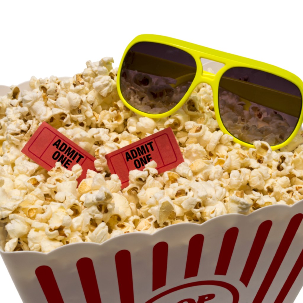 Popcorn with sunglasses and movie tickets