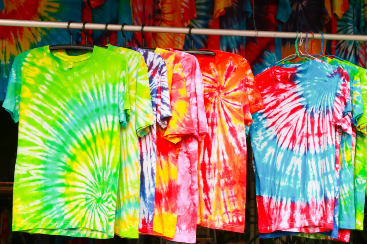 Colorful tie-dye shirts hanging on a line.