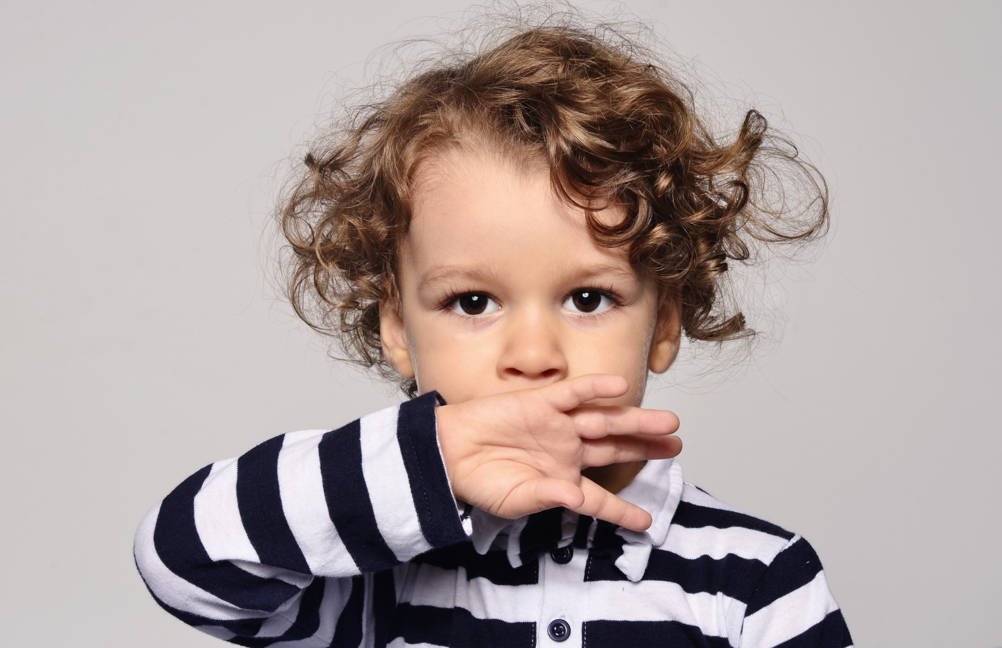 Toddler sucking on back of their hand.