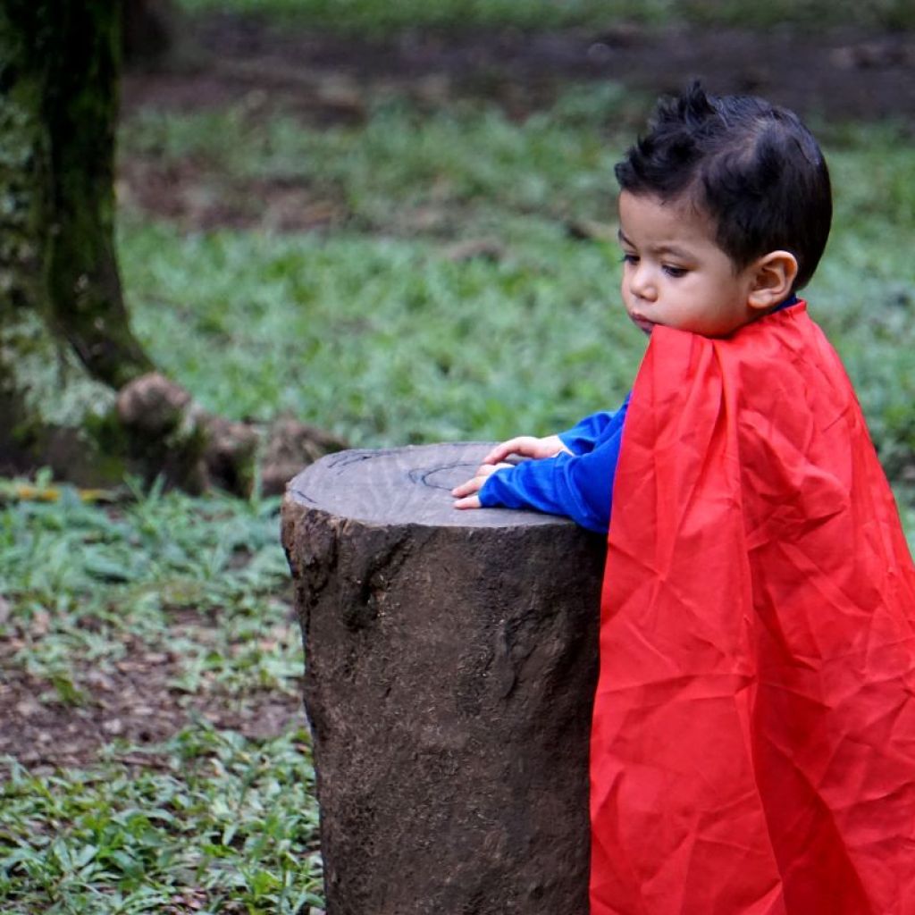 boy wearing red cape