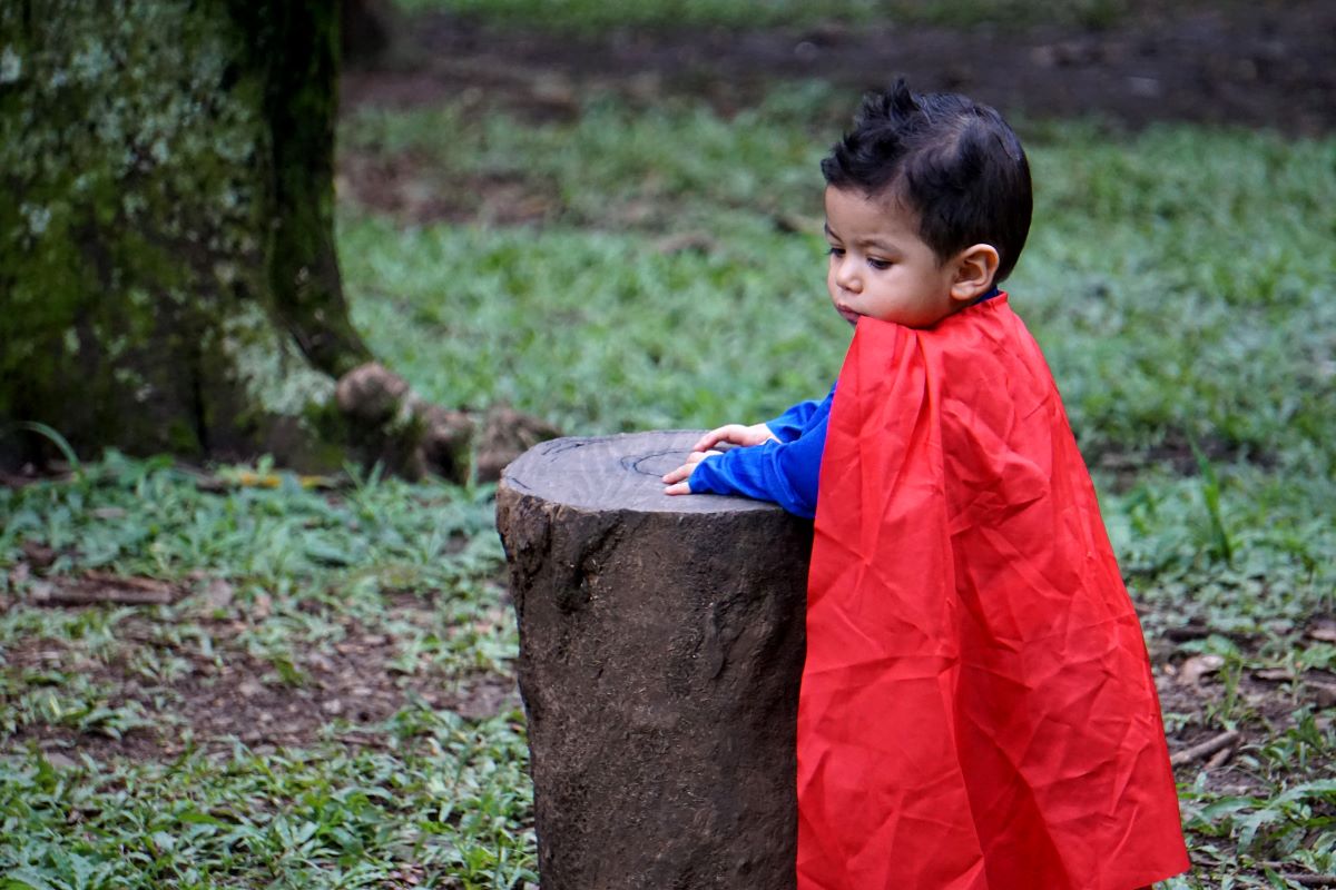 boy wearing red cape
