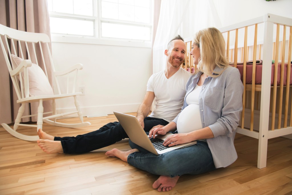 couple sitting in baby room
