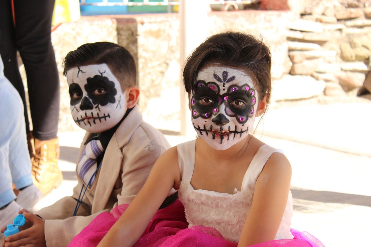 children with faces painted for Dia de los Muertos