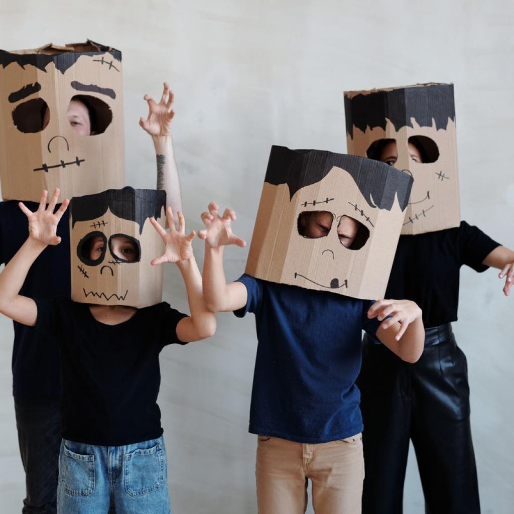 family wearing Halloween masks made from boxes