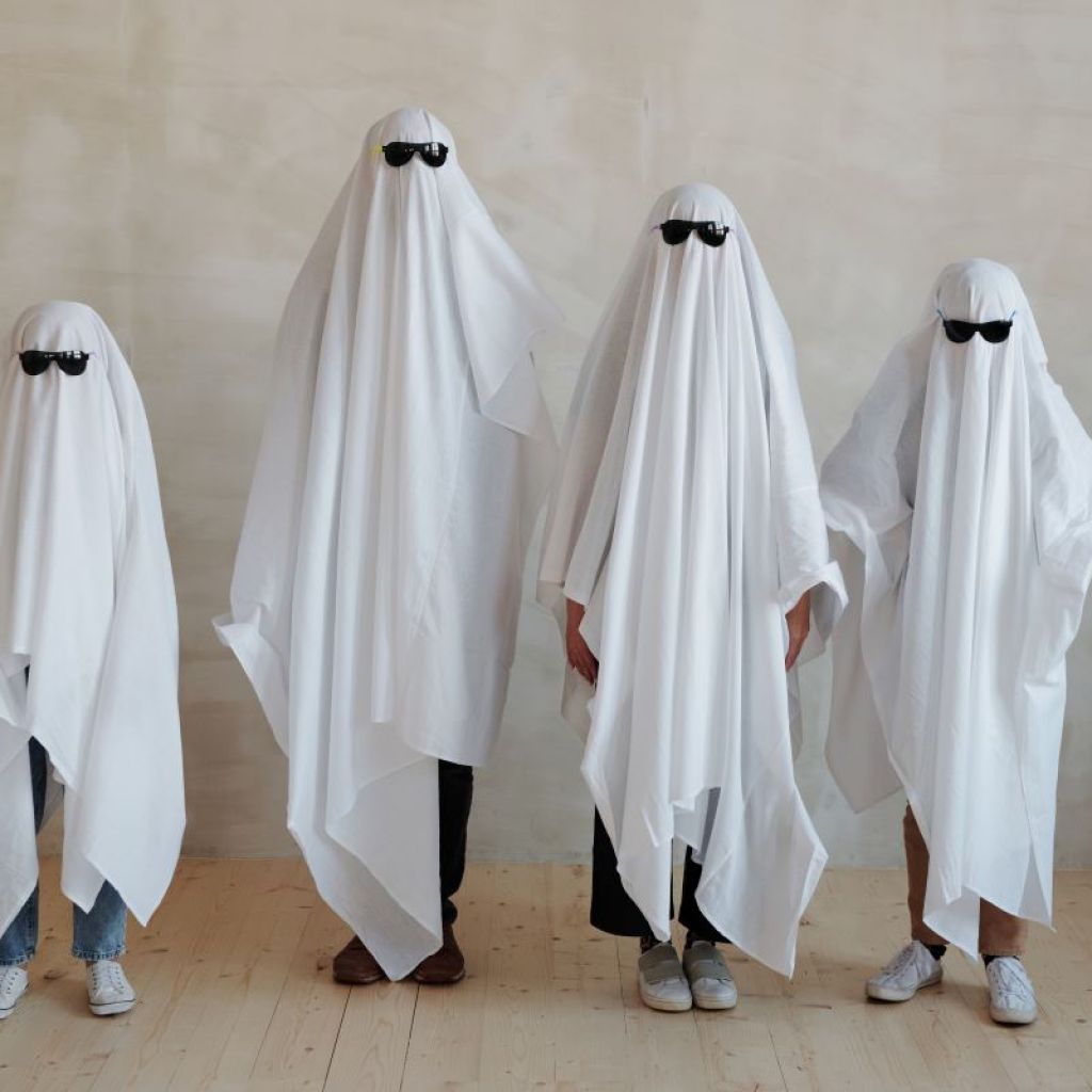 a family dressed as ghosts