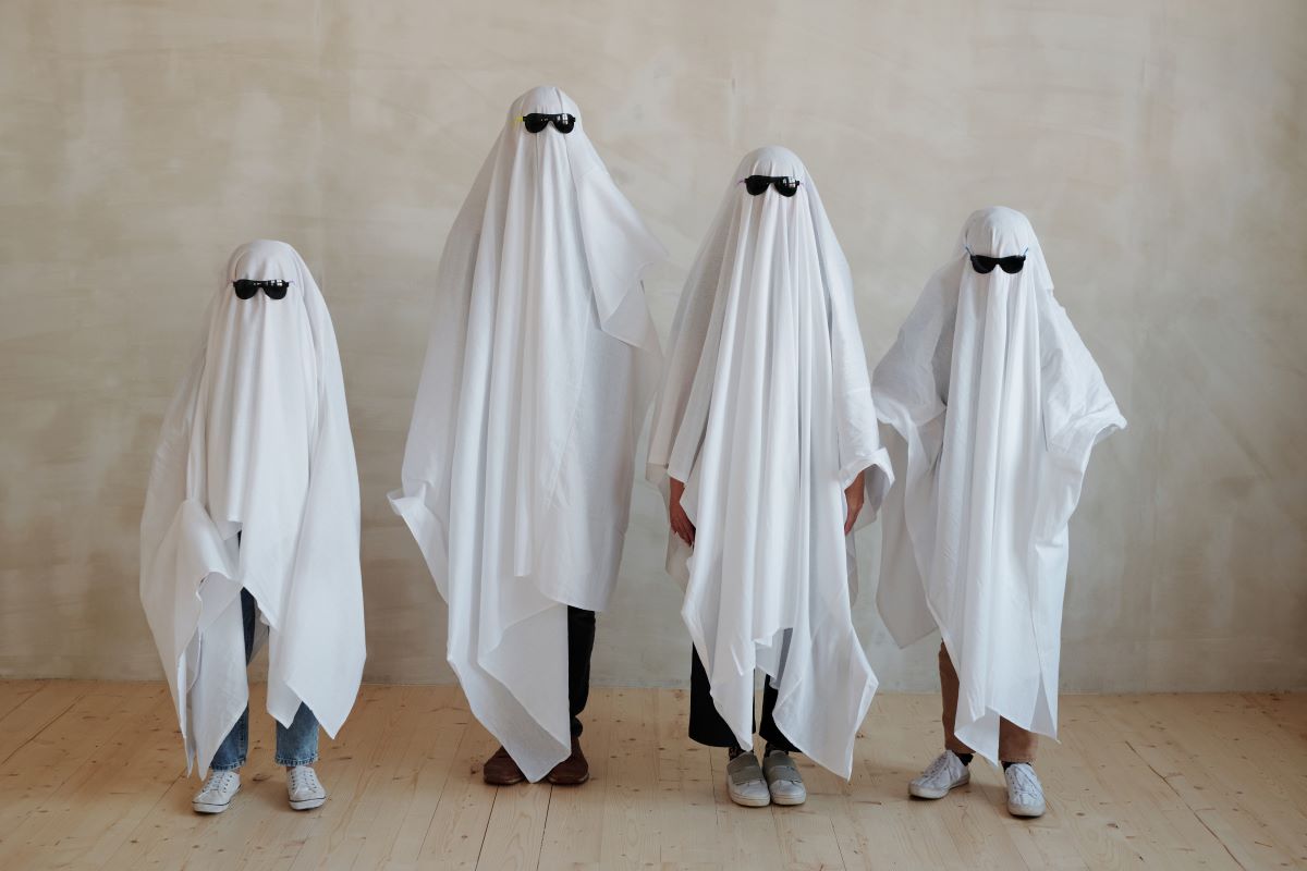 a family dressed as ghosts