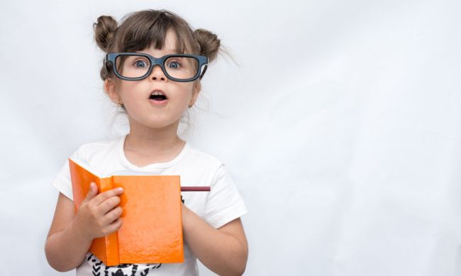 Girl with glasses holding book