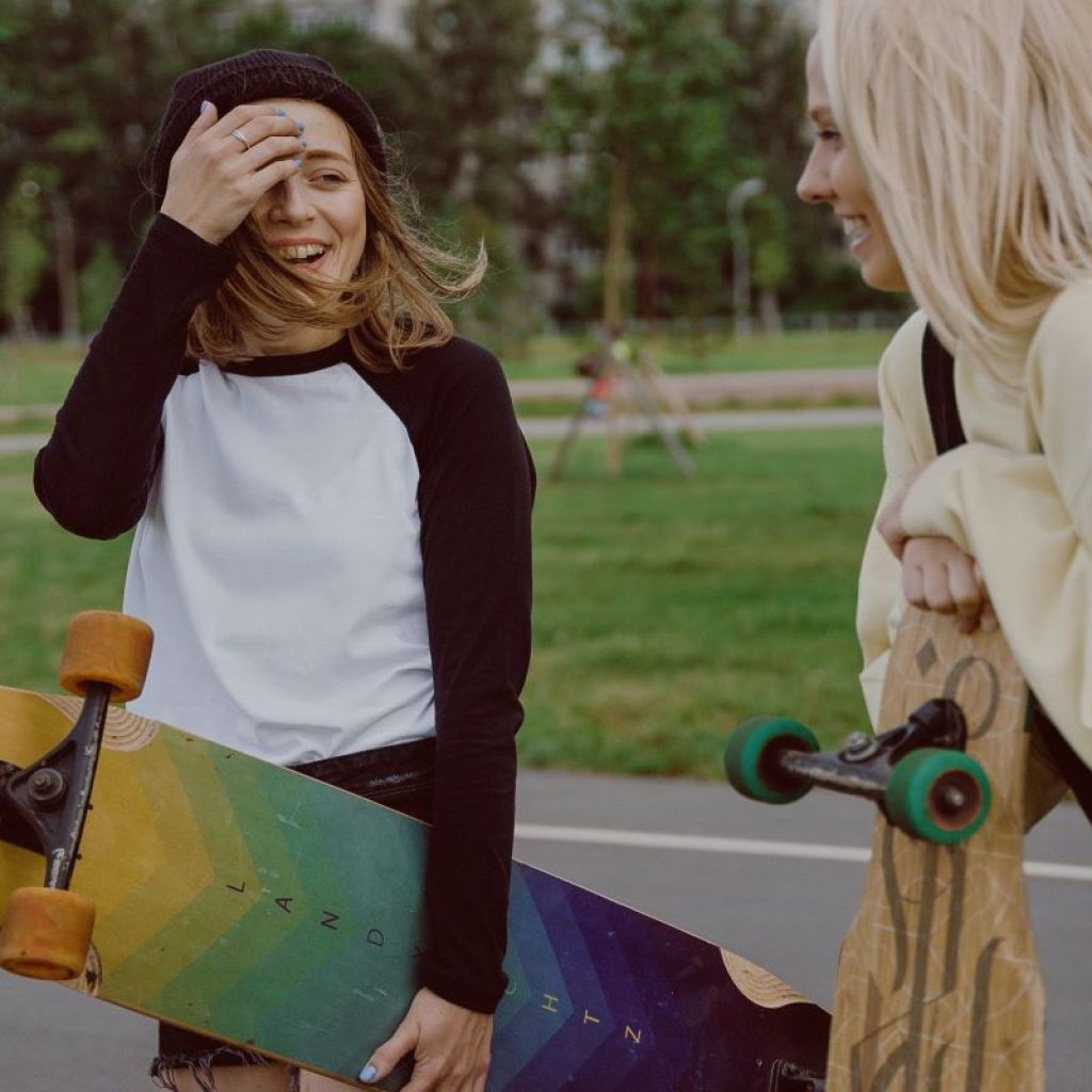 two girls at the park with skateboards
