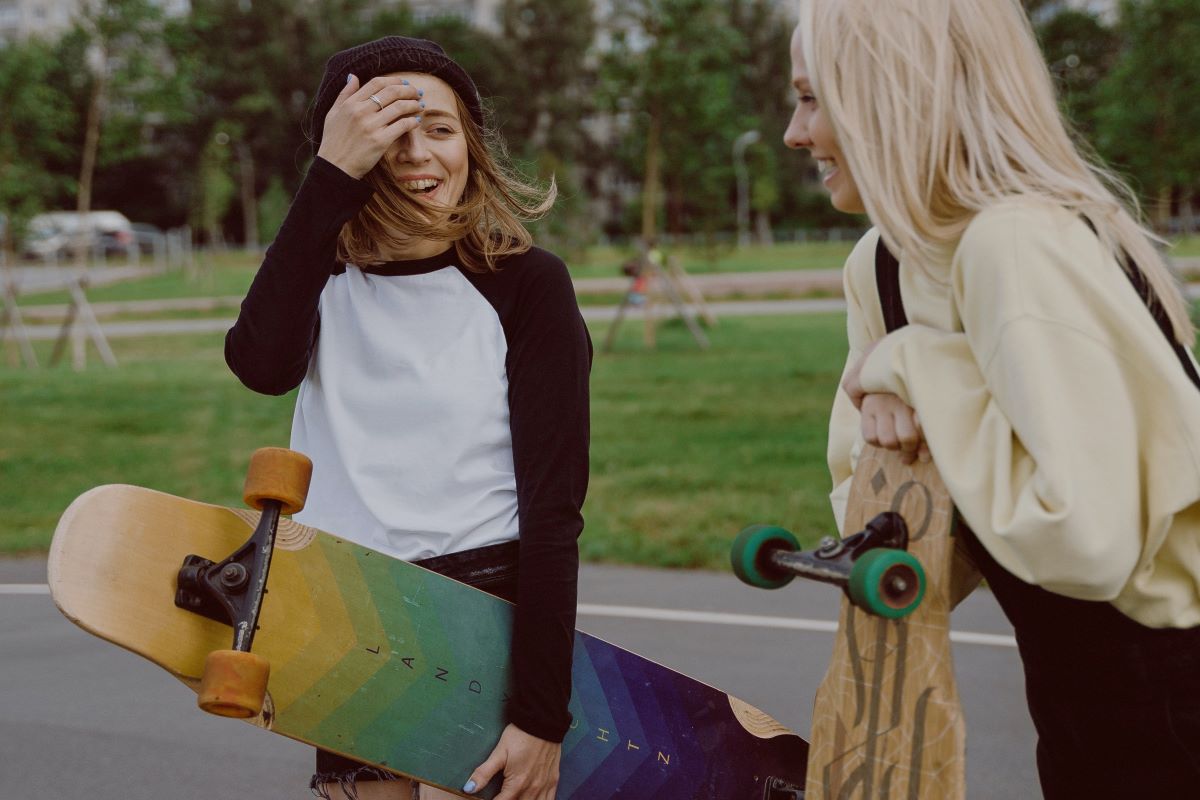 two girls at the park with skateboards